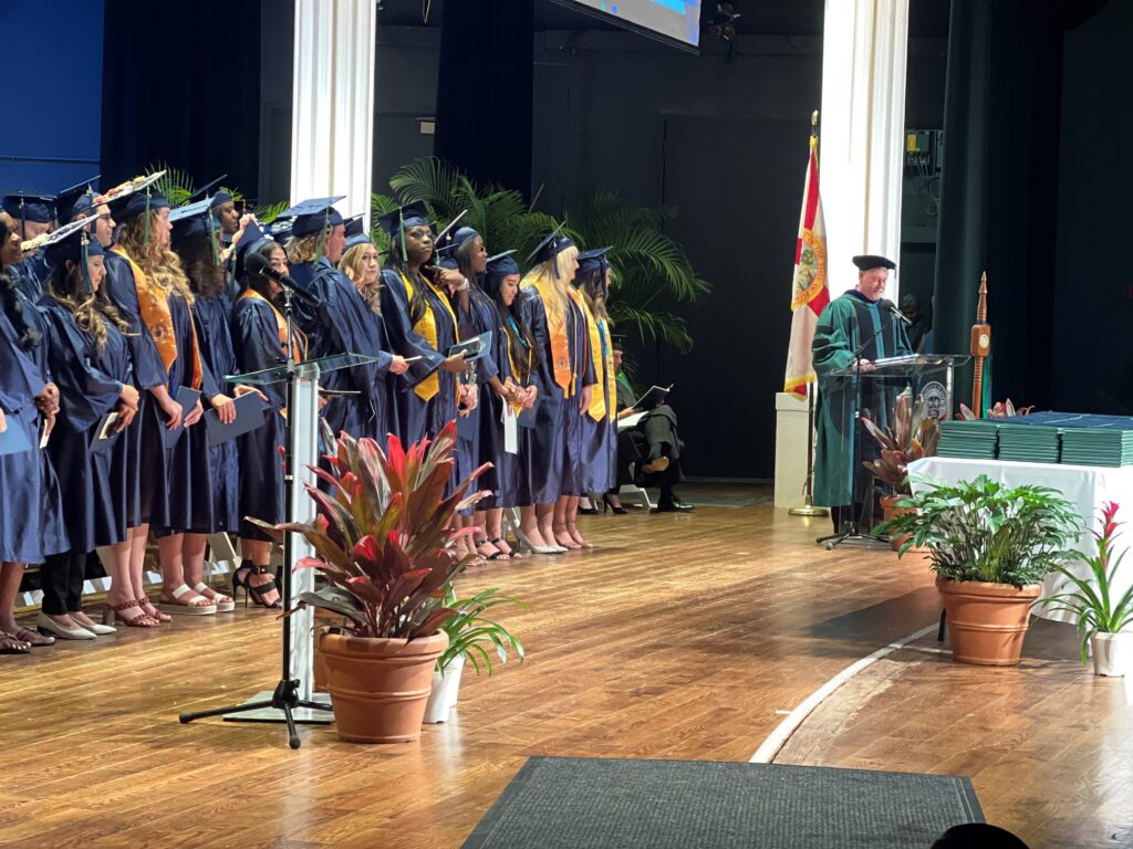 Chris Wellman, associate vice president of facilities management, opens the ceremony while serving as mace bearer.