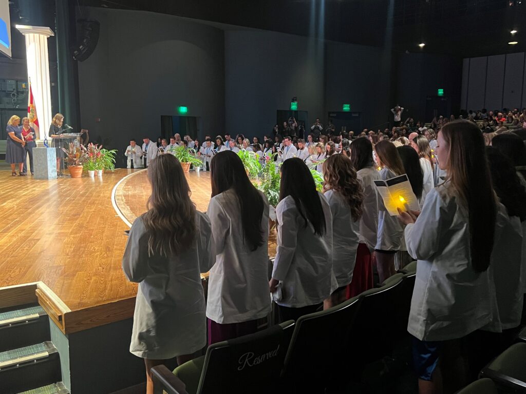 Graduating nurses recite the International Pledge for Nurses at the conclusion of Friday’s pinning ceremony.