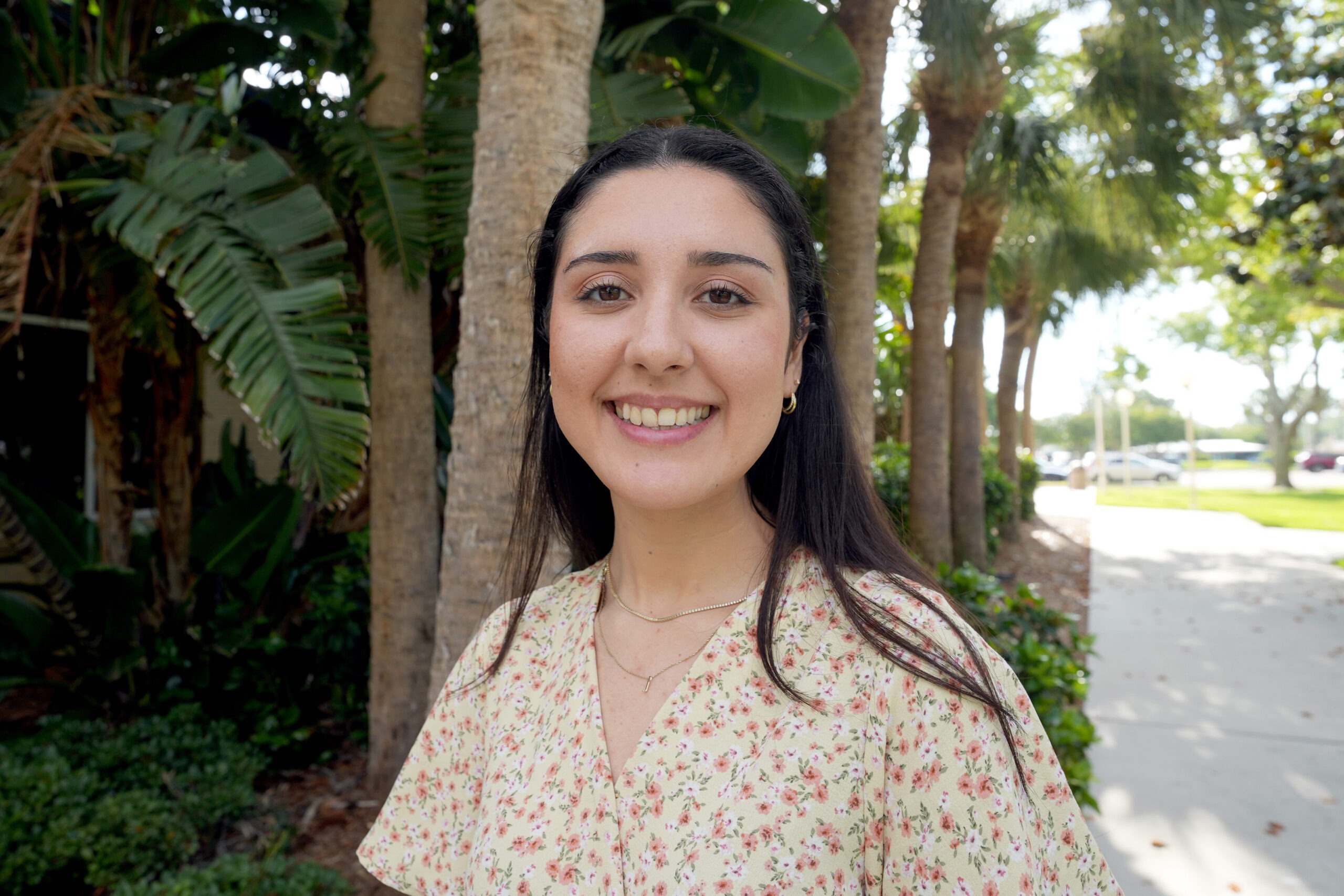 Photo of a woman standing in front of trees on the SCF campus.