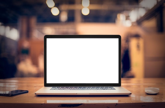 Laptop on a desk with a blank screen