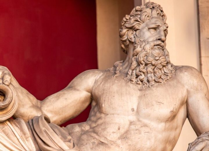 A marble statue of a mythological being reclining.