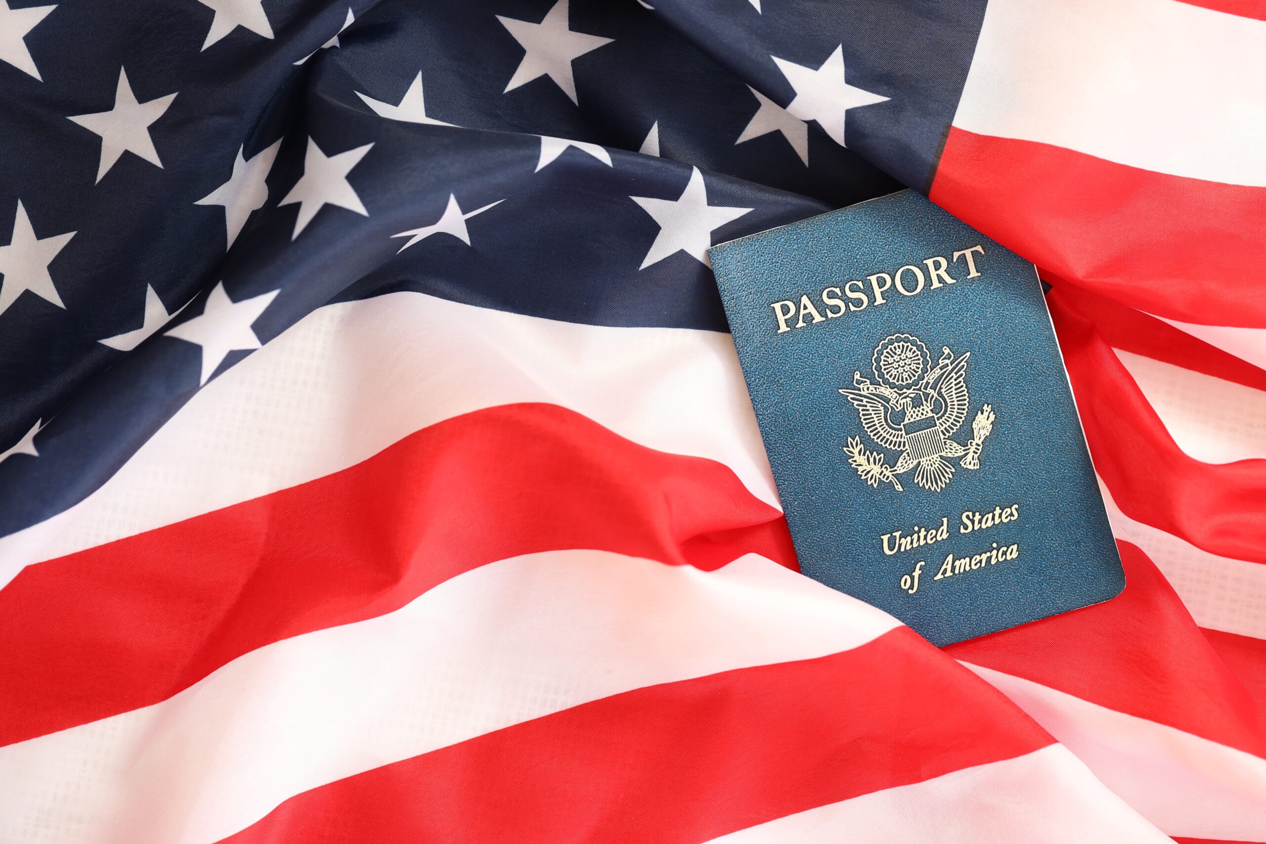 Latest version of United States of America citizen Passport on USA national flag close up